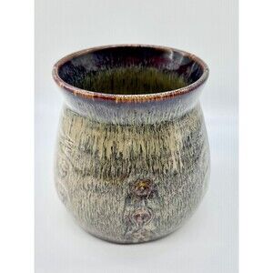 Rustic or artisan pottery planter pot with earthy tones and an organic charm